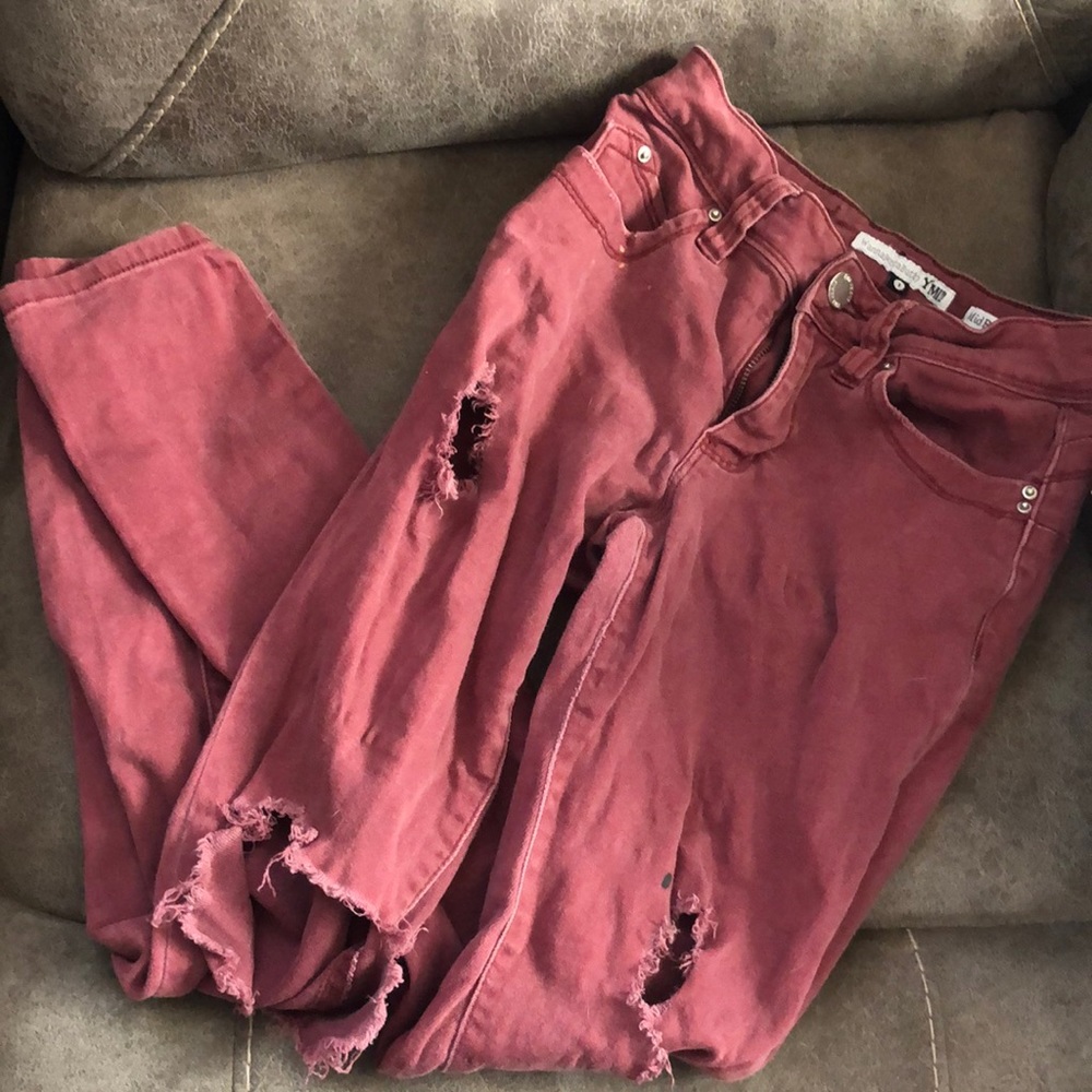Women’s ripped red jeans.